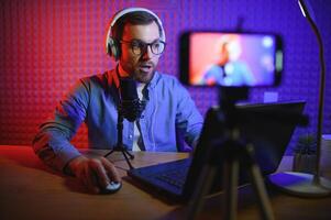 A blogger records content in his studio. The backstage photo was taken from behind one of the participants in the shooting, at the beginning of the shooting when the blogger is preparing.