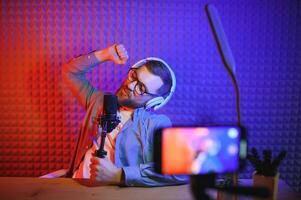 A blogger records content in his studio. The backstage photo was taken from behind one of the participants in the shooting, at the beginning of the shooting when the blogger is preparing.