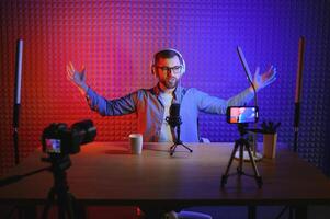 A blogger records content in his studio. The backstage photo was taken from behind one of the participants in the shooting, at the beginning of the shooting when the blogger is preparing.