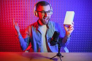 A blogger records content in his studio. The host of the blog is a young man who is very enthusiastic about telling his subscribers a story. photo