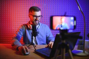 A blogger records content in his studio. The backstage photo was taken from behind one of the participants in the shooting, at the beginning of the shooting when the blogger is preparing.