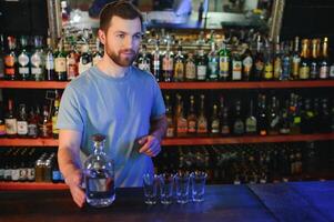 Portrait Of Smiling Male Bar Owner Standing Behind Counter photo