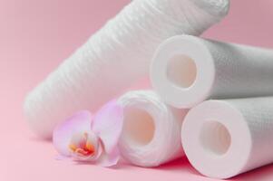 filter cartridges for water on a pink background. Installation of reverse osmosis water purification system. photo