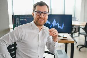 Successful trader in formalwear checking cryptocurrency information data on finance market graph, working in office photo