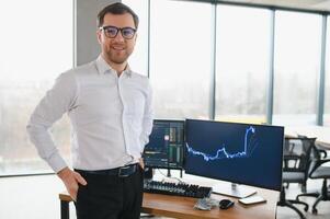 Serious business man trader analyst looking at computer monitor, investor broker analyzing indexes, financial chart trading online investment data on cryptocurrency stock market graph on pc screen. photo
