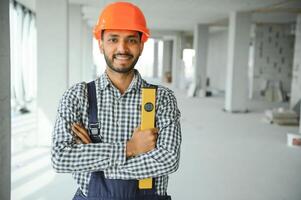 building, construction and people concept. Builder at construction photo