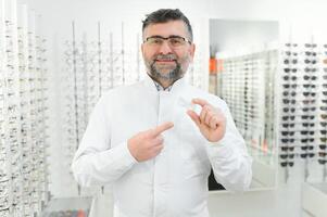 Doctor holds in his hand container with soft contact lenses for single use. Ophthalmologist prescribes use of one-day contact lenses for vision correction. Myopia and eyesight problem concept. photo