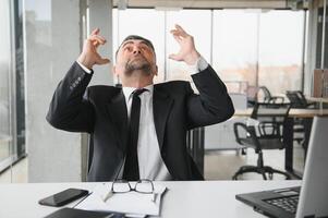 Angry businessman with document shouting at somebody photo