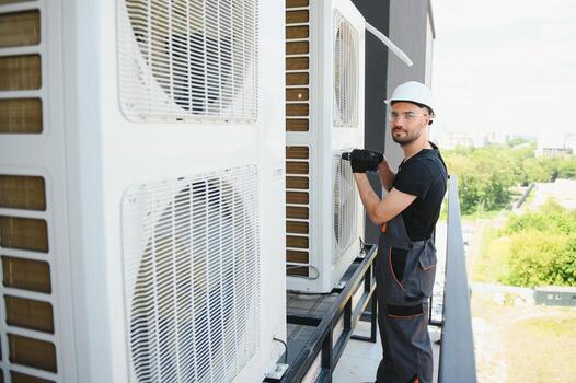 Technician man install new air conditioner, Repairman service for repair and maintenance of air conditioners photo