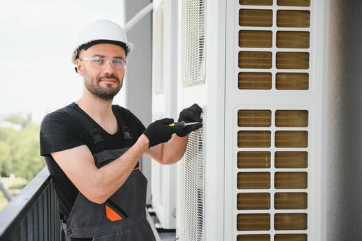 Technician man install new air conditioner, Repairman service for repair and maintenance of air conditioners photo