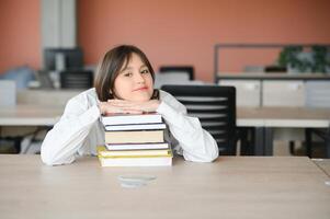 education and school concept - student girl studying and reading book at school. photo