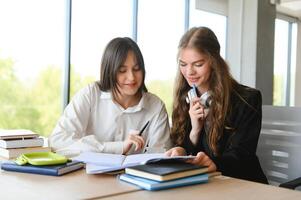 Portrait of two girls at workplace with books. School education photo