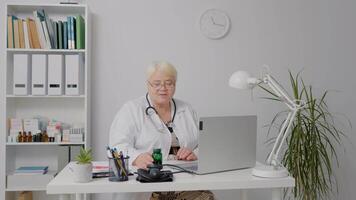 Specialized medical worker having call explaining the benefits of new drug using laptop. video