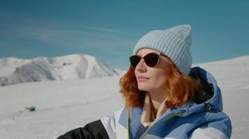 Close up woman deep in thoughts getting energy from the sun while sitting on snow. video