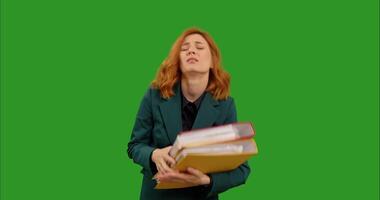 Annoyed bored young woman overwhelmed with assignments in front of green screen background. video