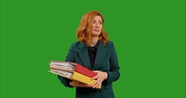 Overwork burnout assistant while holding heavy folders standing In front of green screen background. video