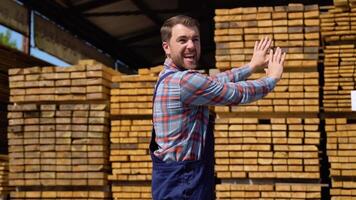 Serious manager in uniform giving commands to workers on lumber warehouse. Bearded man gesturing and shouting during working process video