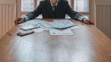 Annual earnings reports are placed on table in the conference room to prepare the paperwork for the board and investors to review annual earnings to adjust and make business plans for the coming year. photo