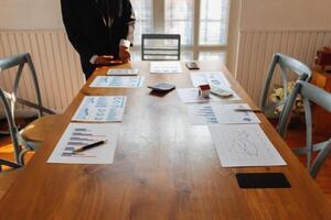 Annual earnings reports are placed on table in the conference room to prepare the paperwork for the board and investors to review annual earnings to adjust and make business plans for the coming year. photo