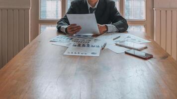 Annual earnings reports are placed on table in the conference room to prepare the paperwork for the board and investors to review annual earnings to adjust and make business plans for the coming year. photo
