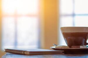 Soft And Blurred images ,Porcelain cups with beautiful patterns are hot coffee mugs that are placed on a wooden table by the window in the morning to fill the coffee for those who need it. photo