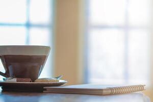 Soft And Blurred images ,Porcelain cups with beautiful patterns are hot coffee mugs that are placed on a wooden table by the window in the morning to fill the coffee for those who need it. photo