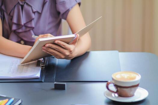 Smooth Focus,The young woman notes the ideas in her notebook to prevent them from forgetting and can actually use the ideas when it's time.Concept note-taking ideas to prevent forgetting photo