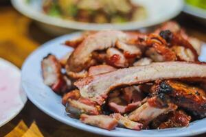 The cooked meat is sliced and served to friends at parties as the meat is scrambling over the charcoal, giving it a delicious aroma and flavor that is perfect for banquets and camping. photo
