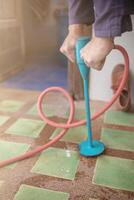 Pest exterminator employees are using pesticide sprayer at client's home and searching for as many nests as possible. An employee from pest control company is spraying chemicals to kill the insects. photo