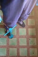 Pest exterminator employees are using pesticide sprayer at client's home and searching for as many nests as possible. An employee from pest control company is spraying chemicals to kill the insects. photo