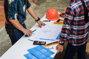 The engineer is giving advice and consulting with the designer to find out the construction site where the engineer will have to construct the project. Consultation between engineers and designers photo