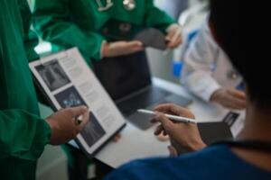 concept of mobilizing ability of medical team in conference room to diagnose and treat disease correctly. medical team joins meeting and discusses patient illness in order to treat it correctly photo