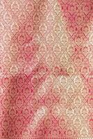 Thai silk with beautiful patterns and a high price because silk is added using ancient methods to produce fibers and weaving with ancient weaving machines resulting in beautiful patterned silk. photo