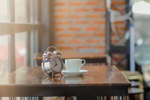 soft Focus,The clock placed on a wooden table by the window is an alarm clock that can be used to set an appointment for reminders.The idea of using an alarm clock as an alarm before the appointment photo