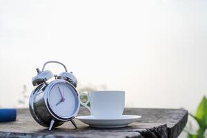 soft Focus,The clock placed on a wooden table by the window is an alarm clock that can be used to set an appointment for reminders.The idea of using an alarm clock as an alarm before the appointment photo