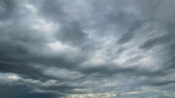 The rain clouds that are forming above the sky are rain clouds of the storms that are bringing moisture into the seasonal areas. The background of the sky is full of black clouds from thunderstorm photo