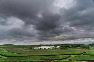 The rain clouds that are forming above the sky are rain clouds of the storms that are bringing moisture into the seasonal areas. The background of the sky is full of black clouds from thunderstorm photo