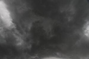 The rain clouds that are forming above the sky are rain clouds of the storms that are bringing moisture into the seasonal areas. The background of the sky is full of black clouds from thunderstorm photo