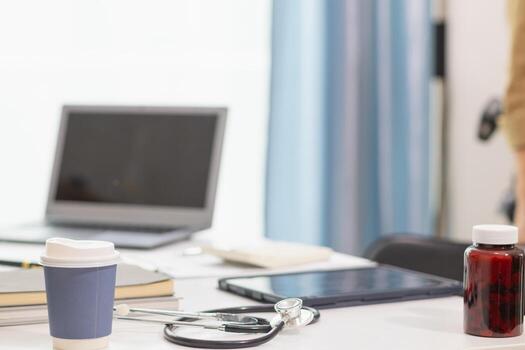 stethoscope is placed on work desk in doctor office After examining patient stethoscope is placed on the work desk to examine additional information from the computer that has compiled the results. photo