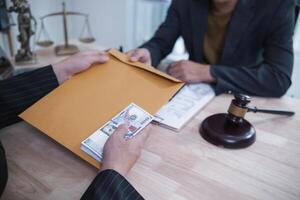 The businessman offered cash to prosecutors as a bribe to help change the verdict in the case, knowing that bribery is a serious and illegal crime. The concept of bribing government officials photo