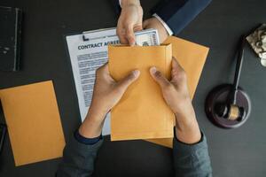 The businessman offered cash to prosecutors as a bribe to help change the verdict in the case, knowing that bribery is a serious and illegal crime. The concept of bribing government officials photo