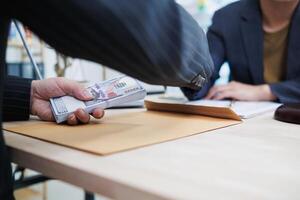 The businessman offered cash to prosecutors as a bribe to help change the verdict in the case, knowing that bribery is a serious and illegal crime. The concept of bribing government officials photo