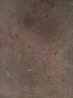 Close-up of a cracked building wall textured background. Suitable for additional design projects. photo