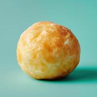 Scrumptious golden brown donut on a mint green background photo