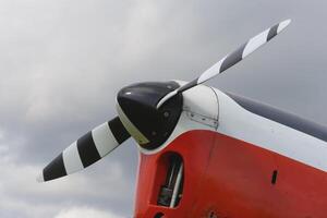 A red light aircraft. Fragment of a propeller of the front part of . Close-up, screws, texture, surface photo