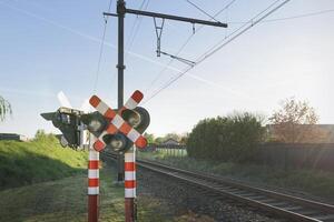 Railway traffic light. Railway crossing. Warning road sign about the proximity of a railway crossing. photo