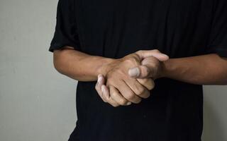Man showing word believe on beige background photo