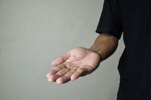 Man holds in his hands his fallen milk tooth photo