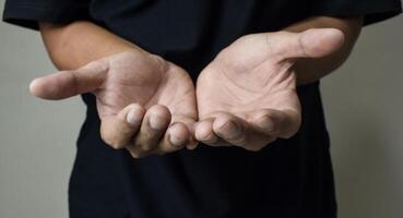 Man praying to god with hands together on beige background photo