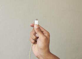 Close up Man hands holding usb-c cord photo